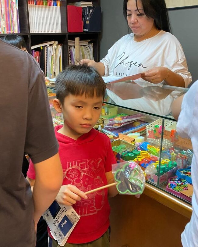 Primary student collecting prize using earned points