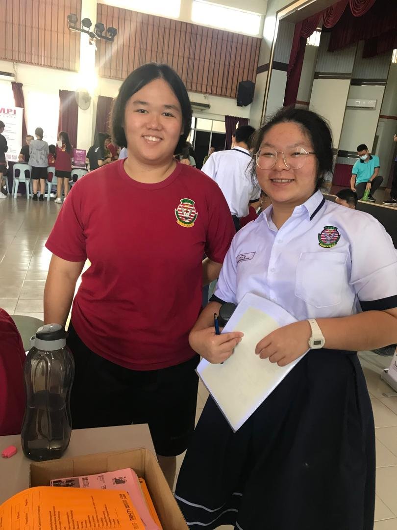 Admission counselors assisting students at university booth