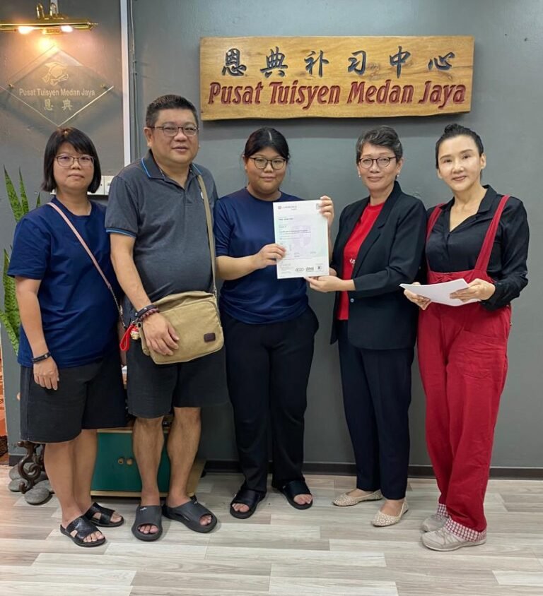 Student awarded certificate while parent looks on happily