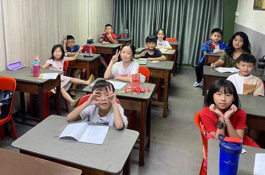 Young students smiling as photographer takes their photo