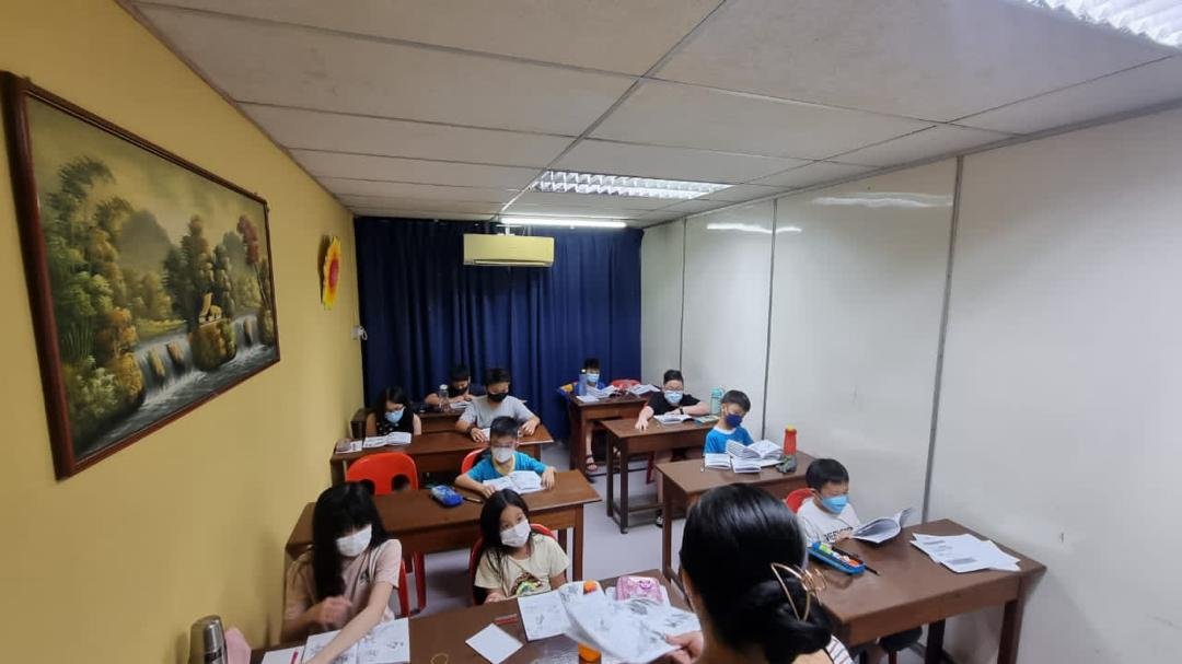 Smiling students learning basic English words with visual aids